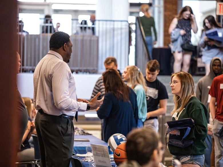 Photo of admissions staff talking with students